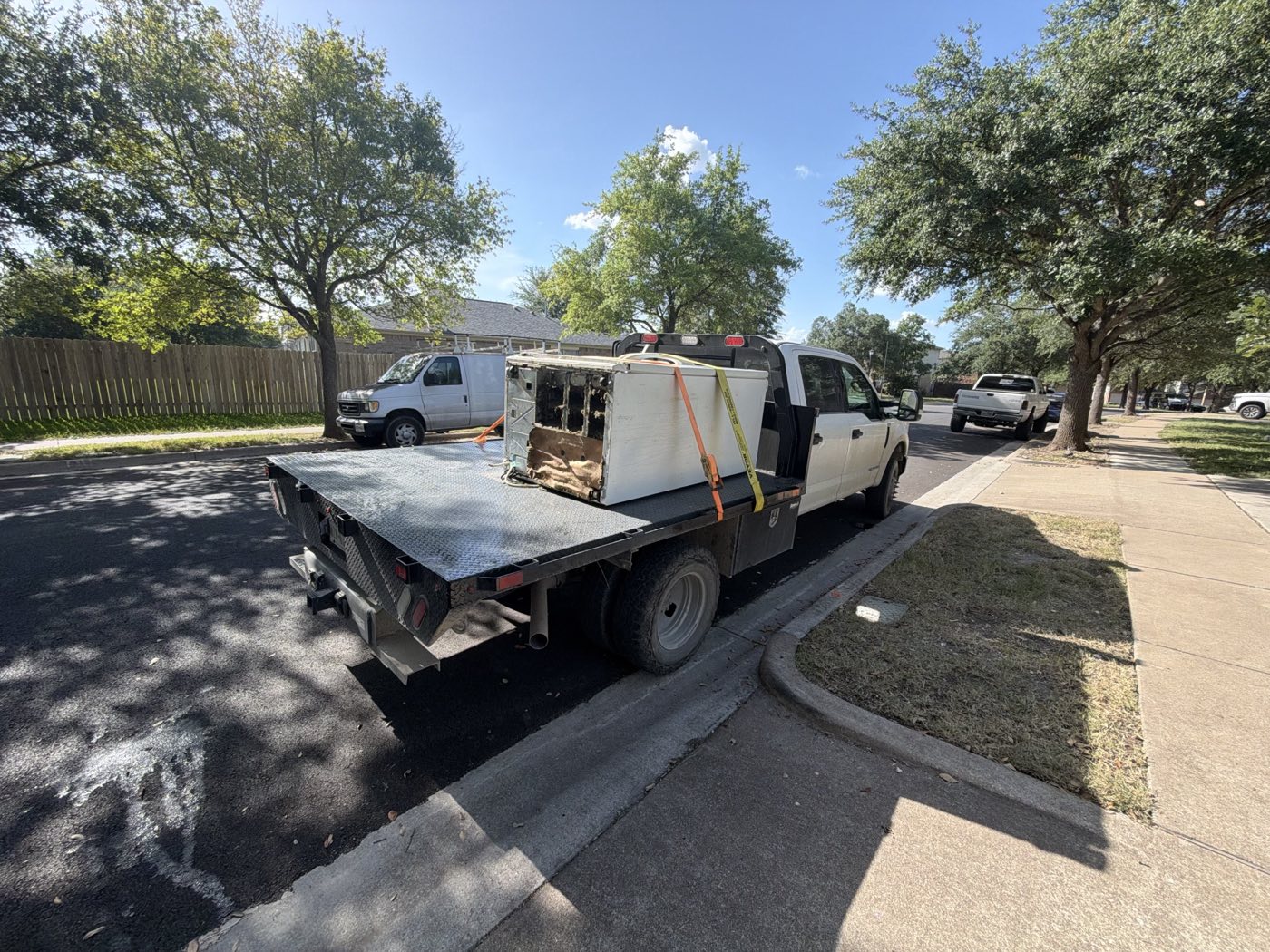 JATS crew truck hauling an old refrigerator away from a home in Central Texas