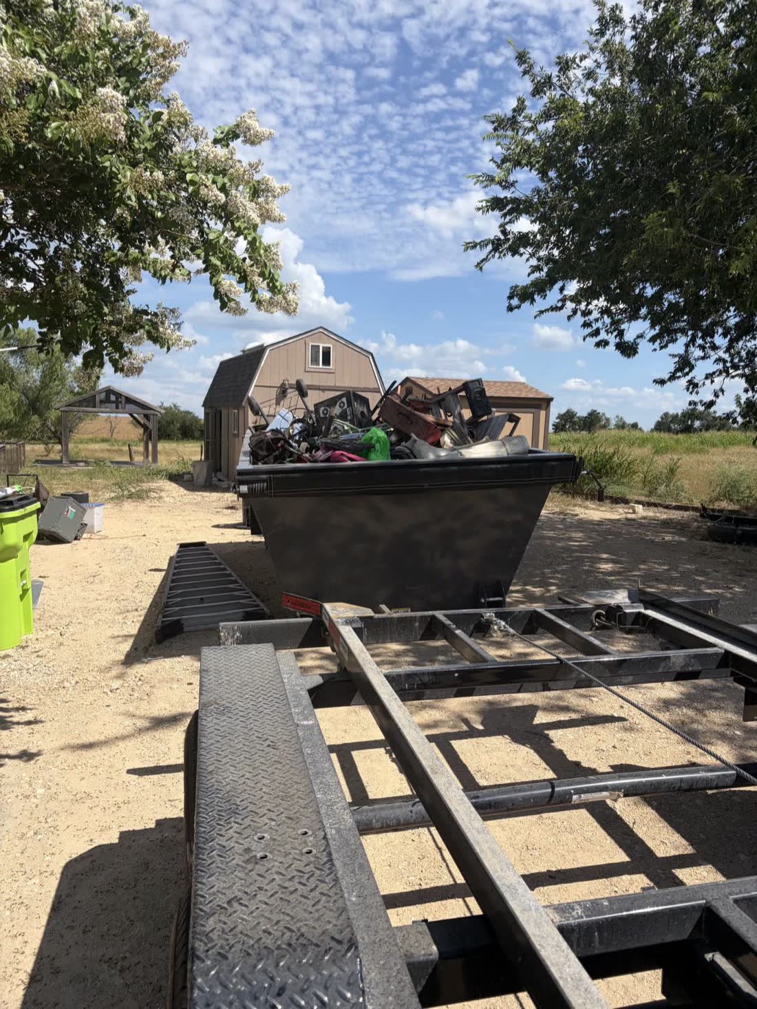 JATS 15-yard dumpster loaded with junk at a property cleanout
